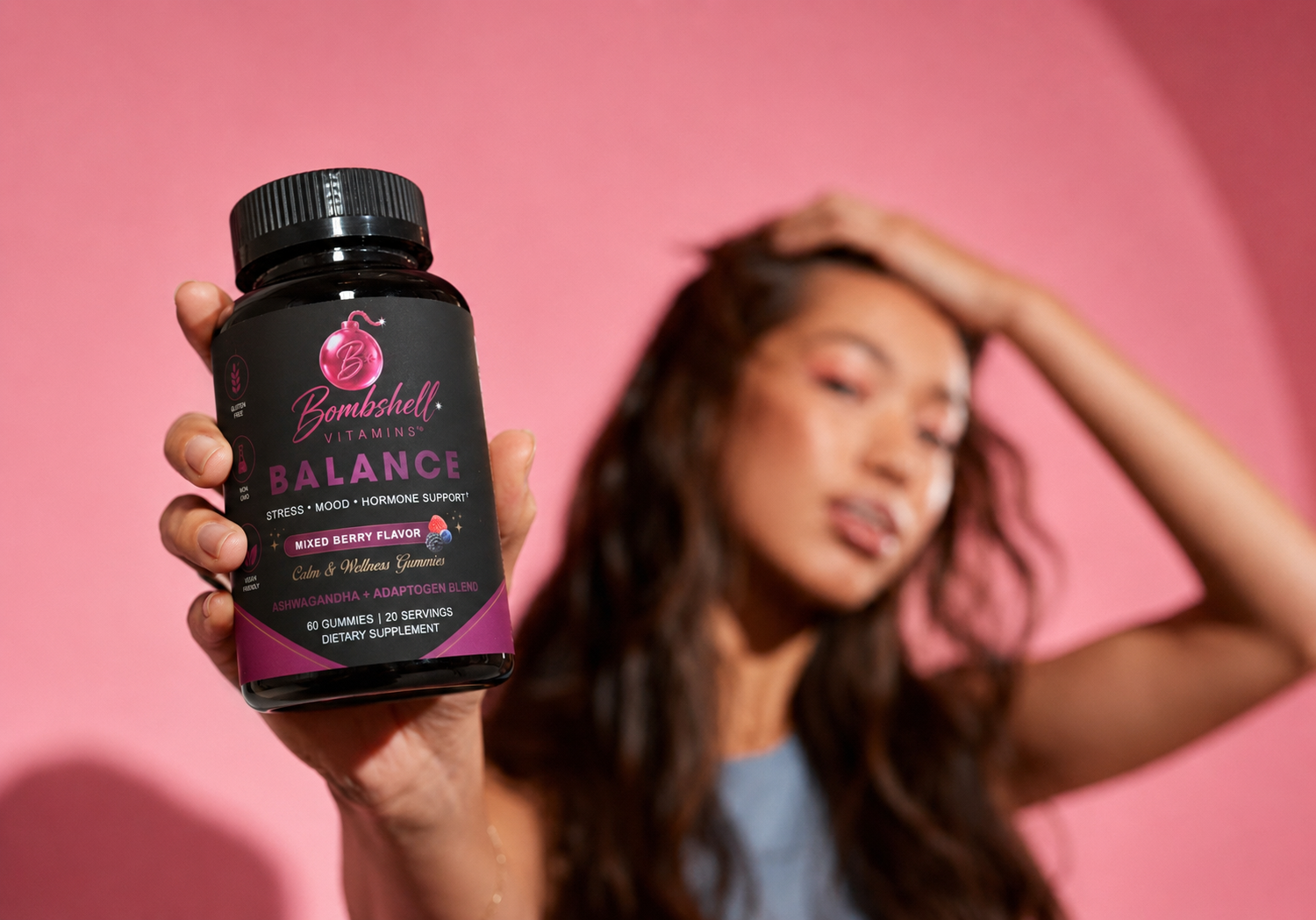 A hand holding a bottle of Bombshell Balance