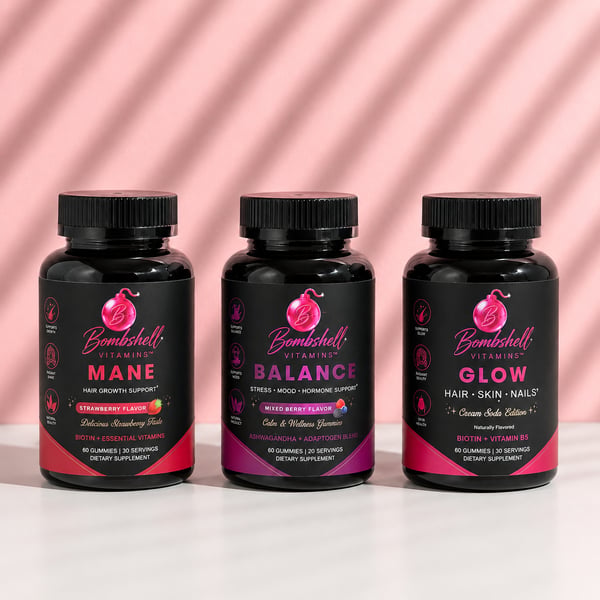 Bottles of Bombshell Mane, Balance and Glow together against a pink background