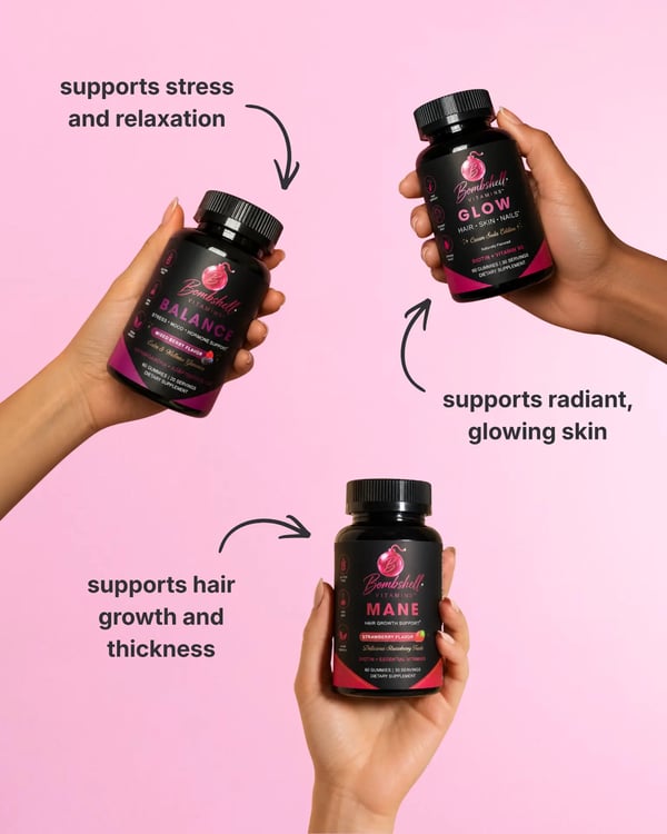 Three hands each holding a Bombshell bottle — Balance, Glow and Mane — against a pink background